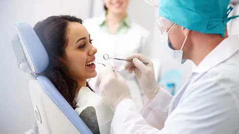 A dentist giving a patient a check up