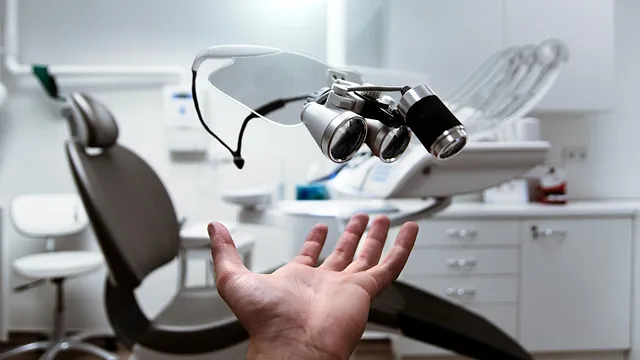 A dentist throwing his dentist in the air